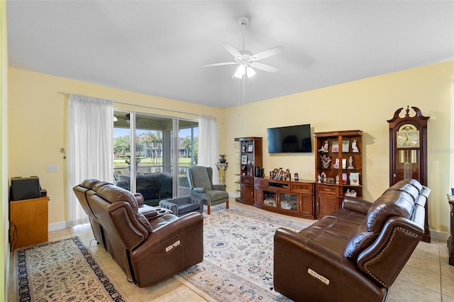 living room featuring light tile patterned floors, ceiling fan, and baseboards