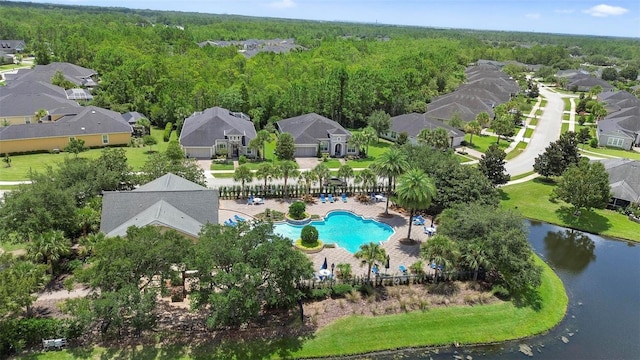 bird's eye view with a residential view, a water view, and a view of trees