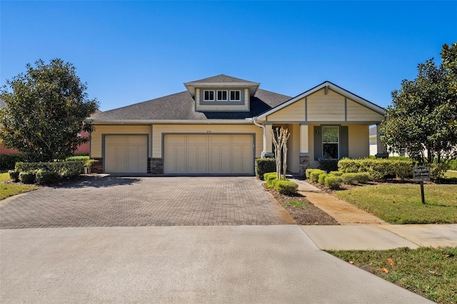 309 Chesham St, Ormond Beach, FL 32174 - view of front of home with driveway, a garage, stone siding, covered porch, and a front lawn