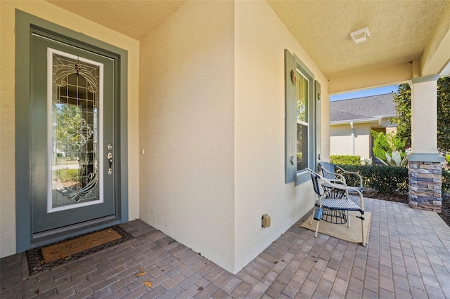 309 Chesham St, Ormond Beach, FL 32174 - view of exterior entry with covered porch and stucco siding