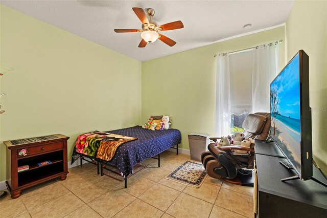 309 Chesham St, Ormond Beach, FL 32174 - tiled bedroom featuring ceiling fan and baseboards