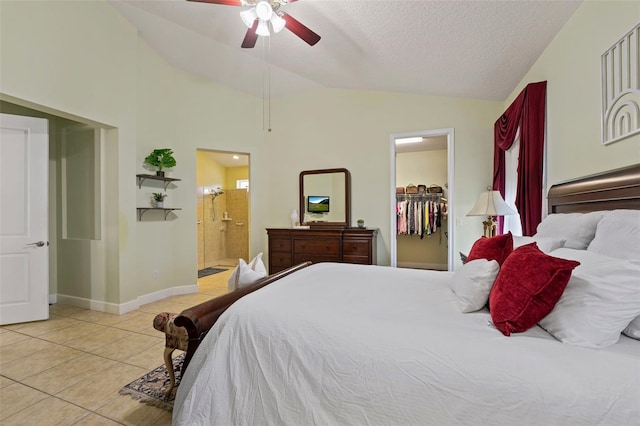 309 Chesham St, Ormond Beach, FL 32174 - bedroom featuring lofted ceiling, light tile patterned floors, a walk in closet, ensuite bathroom, and a textured ceiling