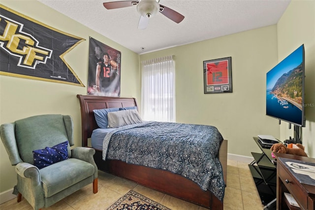 309 Chesham St, Ormond Beach, FL 32174 - tiled bedroom featuring a textured ceiling, ceiling fan, and baseboards