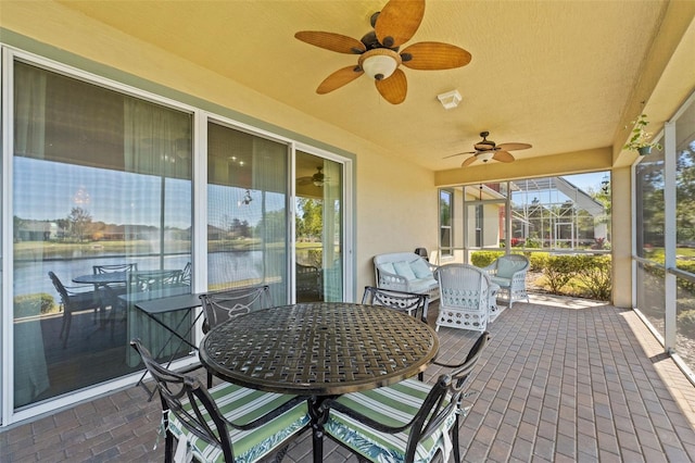 309 Chesham St, Ormond Beach, FL 32174 - sunroom with a ceiling fan, outdoor dining area, and a water view
