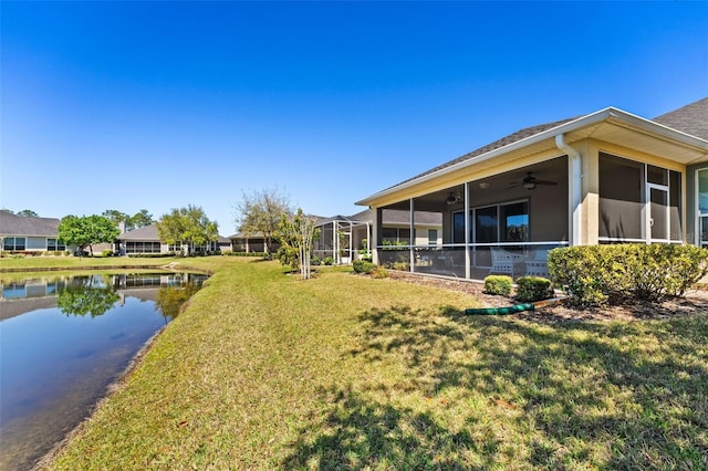309 Chesham St, Ormond Beach, FL 32174 - view of green lawn with ceiling fan, a water view, and a sunroom