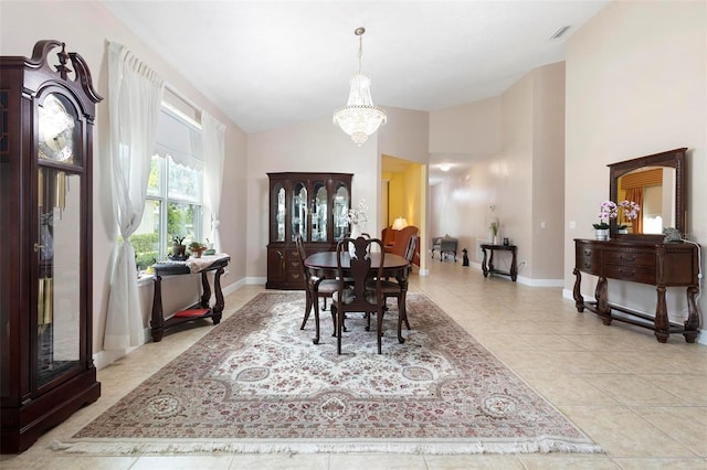 309 Chesham St, Ormond Beach, FL 32174 - dining room with a chandelier, light tile patterned floors, baseboards, and high vaulted ceiling