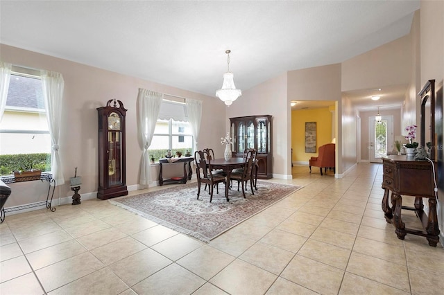 309 Chesham St, Ormond Beach, FL 32174 - dining area with light tile patterned floors, baseboards, and vaulted ceiling