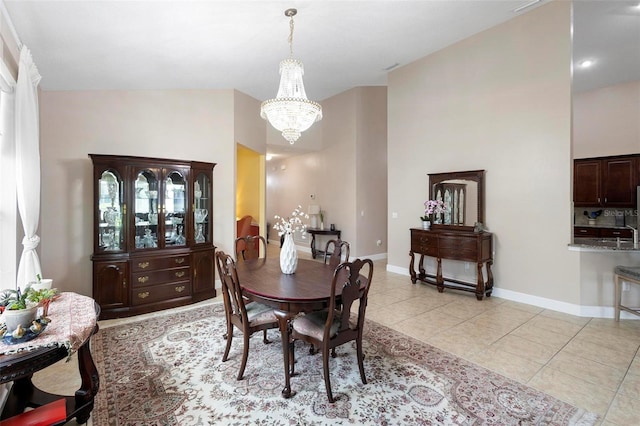 309 Chesham St, Ormond Beach, FL 32174 - dining area with a chandelier, light tile patterned floors, and baseboards