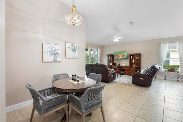 309 Chesham St, Ormond Beach, FL 32174 - dining space with light tile patterned flooring, ceiling fan, baseboards, and a chandelier