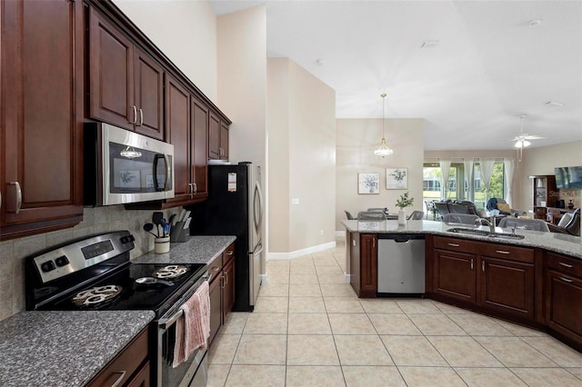 309 Chesham St, Ormond Beach, FL 32174 - kitchen with appliances with stainless steel finishes, open floor plan, decorative backsplash, light tile patterned floors, and a ceiling fan