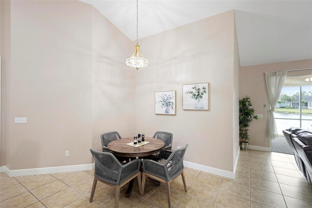 309 Chesham St, Ormond Beach, FL 32174 - dining space with a chandelier, baseboards, light tile patterned floors, and high vaulted ceiling