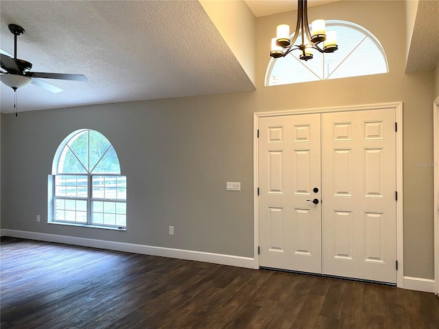 entrance foyer with dark hardwood / wood-style floors, ceiling fan with notable chandelier, and a textured ceiling