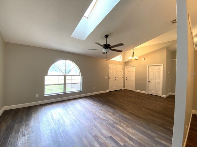 unfurnished living room featuring ceiling fan, dark wood-type flooring, and vaulted ceiling with skylight