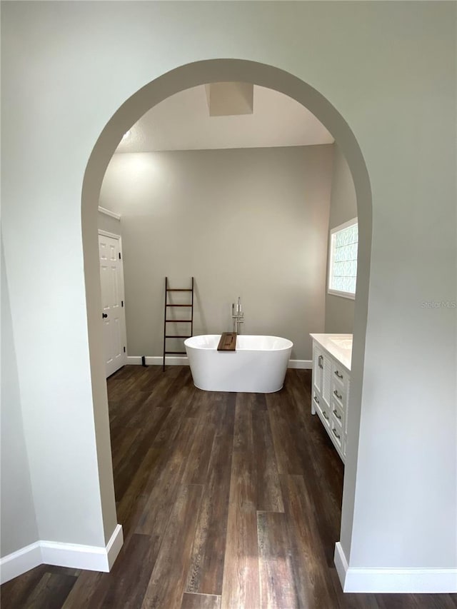 bathroom featuring vanity, a bathing tub, and hardwood / wood-style floors