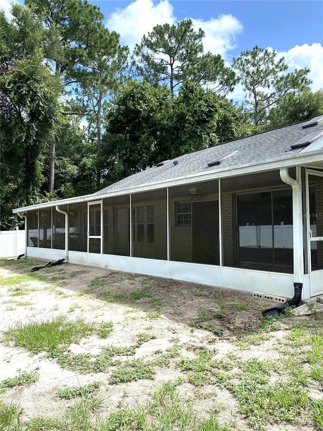 rear view of property with a sunroom