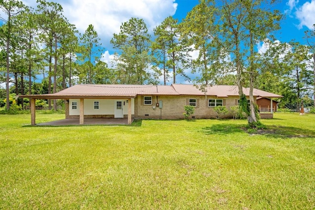 rear view of house with a lawn