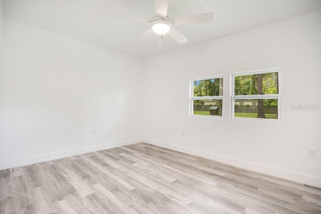 empty room featuring ceiling fan and light wood-type flooring