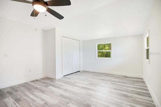 unfurnished bedroom featuring ceiling fan, light hardwood / wood-style flooring, and a closet