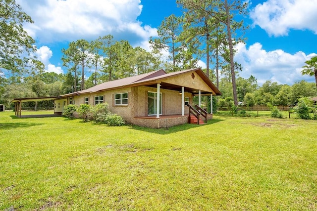 back of house featuring a yard