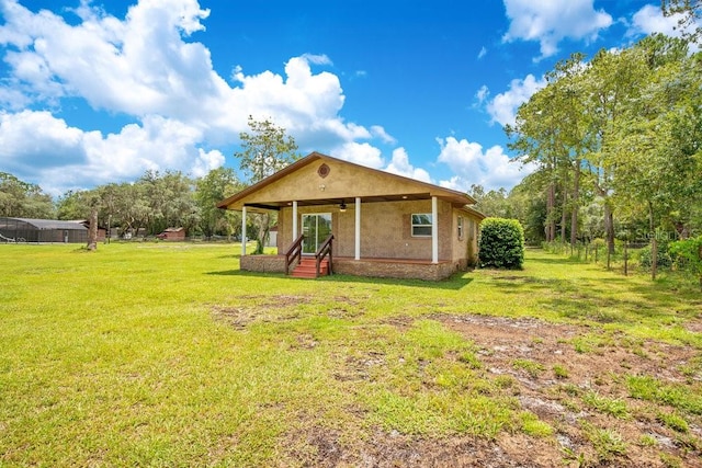 back of property with a lawn