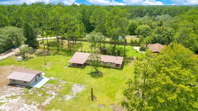 birds eye view of property with a wooded view