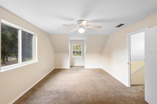 additional living space featuring carpet flooring, ceiling fan, and lofted ceiling