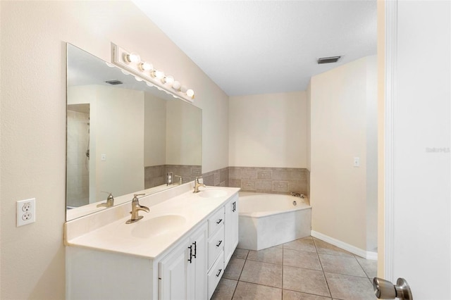 bathroom with vanity, tile patterned floors, and a bathing tub