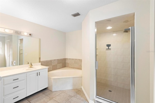 bathroom featuring vanity, tile patterned flooring, and plus walk in shower