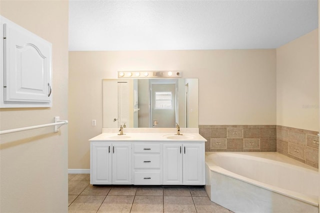 bathroom featuring vanity, tile patterned floors, and a bathtub