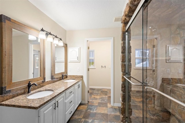 bathroom featuring vanity and a shower with shower door