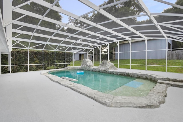 view of swimming pool with a lanai, a patio area, and a lawn