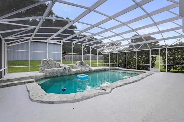 view of swimming pool featuring a lanai, a yard, and a patio