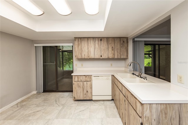 34 Fairway Dr Unit 1, Debary, FL 32713 - kitchen featuring white dishwasher, light countertops, a raised ceiling, light marble finish floors, and light brown cabinets