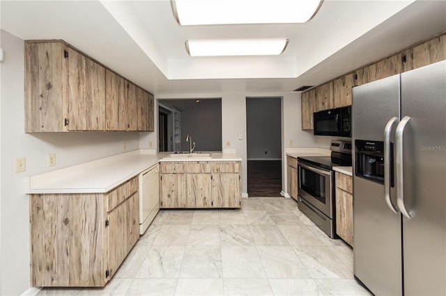 34 Fairway Dr Unit 1, Debary, FL 32713 - kitchen featuring appliances with stainless steel finishes, light countertops, a tray ceiling, a peninsula, and light marble finish flooring