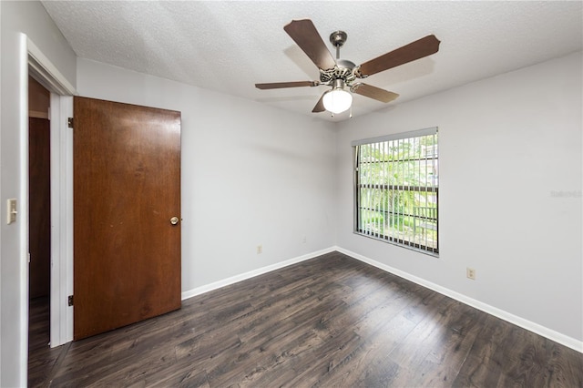 unfurnished room featuring ceiling fan, dark hardwood / wood-style flooring, and a textured ceiling