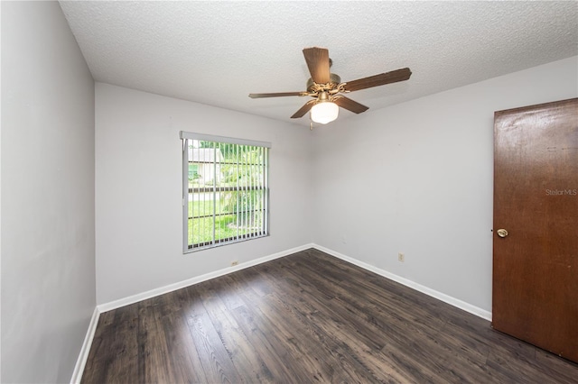 empty room with ceiling fan, dark hardwood / wood-style floors, and a textured ceiling