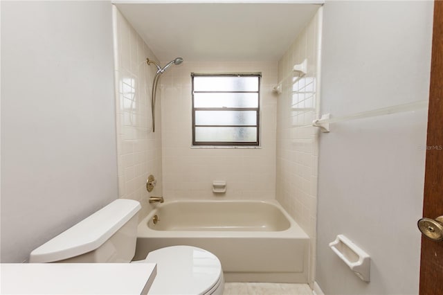 bathroom featuring tiled shower / bath and toilet