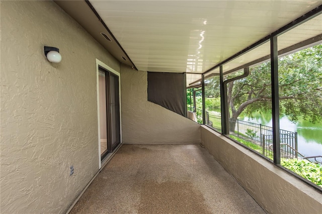 unfurnished sunroom with a water view