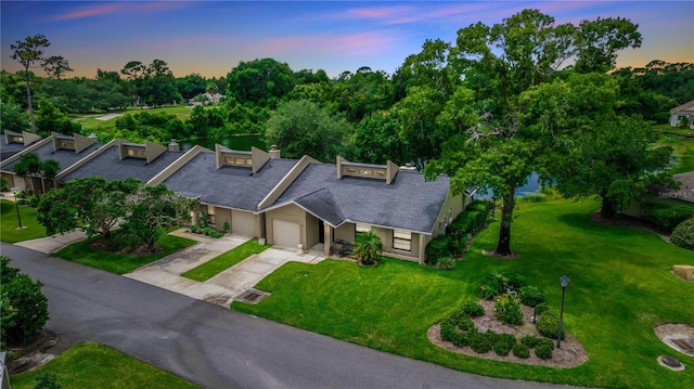 34 Fairway Dr Unit 1, Debary, FL 32713 - view of front facade featuring a garage, concrete driveway, a front yard, and a shingled roof