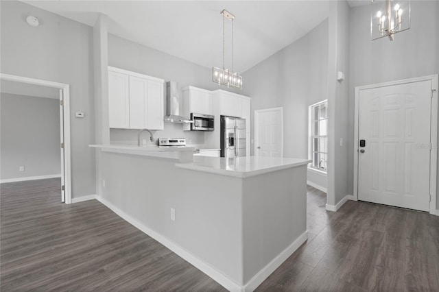 kitchen featuring high vaulted ceiling, wall chimney exhaust hood, dark hardwood / wood-style floors, and stainless steel appliances