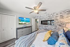 bedroom featuring ceiling fan, a closet, and wood-type flooring