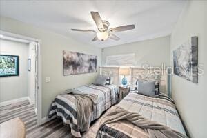 bedroom with wood-type flooring and ceiling fan