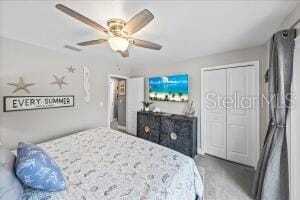 bedroom with a closet, carpet, and ceiling fan