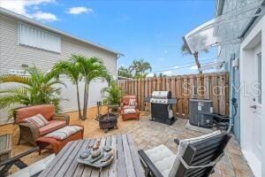 wooden terrace featuring an outdoor hangout area, a grill, and cooling unit