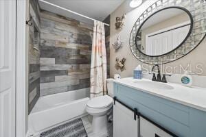 full bathroom featuring vanity, shower / tub combo, tile patterned flooring, and toilet