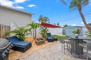 view of patio / terrace featuring an outbuilding and exterior bar