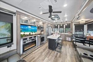 living room with hardwood / wood-style flooring and ceiling fan