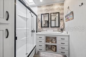 bathroom featuring a skylight and vanity