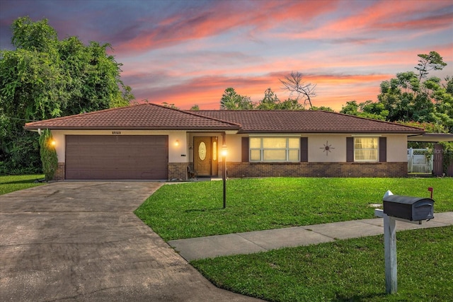 view of front of home featuring a garage and a lawn