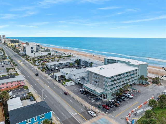 drone / aerial view with a water view and a view of the beach